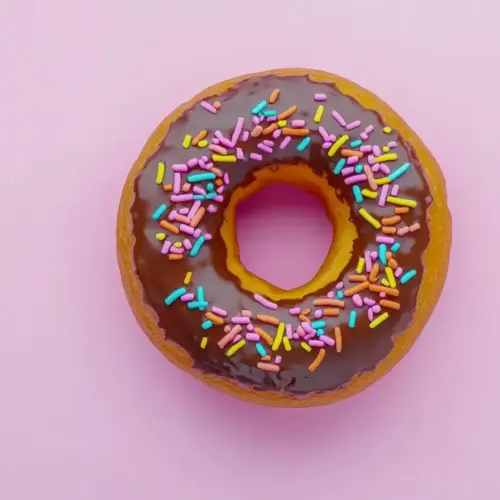 A close-up of a chocolate frosted donut, glossy frosting, high-quality, hyperrealistic.