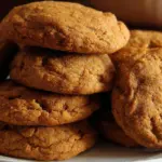 Chewy maple pumpkin cookies topped with spice and drizzled with maple glaze