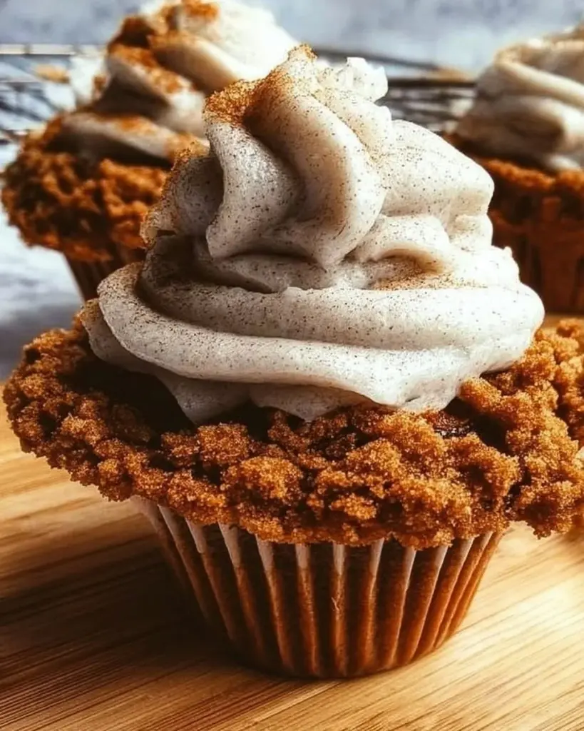 Oatmeal Cream Pie Cupcakes topped with creamy frosting and oatmeal cookie base
