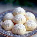 Delicious snowball cookies made with sweetened condensed milk, dusted with powdered sugar.