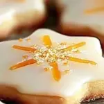 Cardamom shortbread cookies topped with a zesty orange glaze, ready to enjoy.