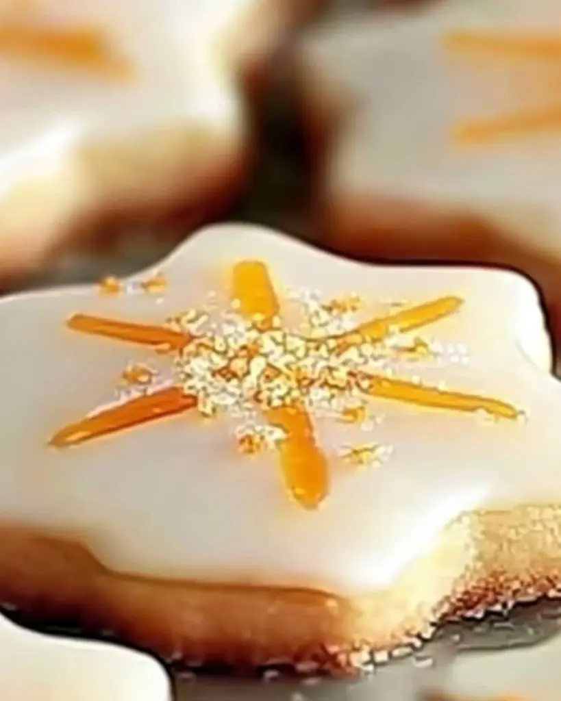 Cardamom shortbread cookies topped with a zesty orange glaze, ready to enjoy.