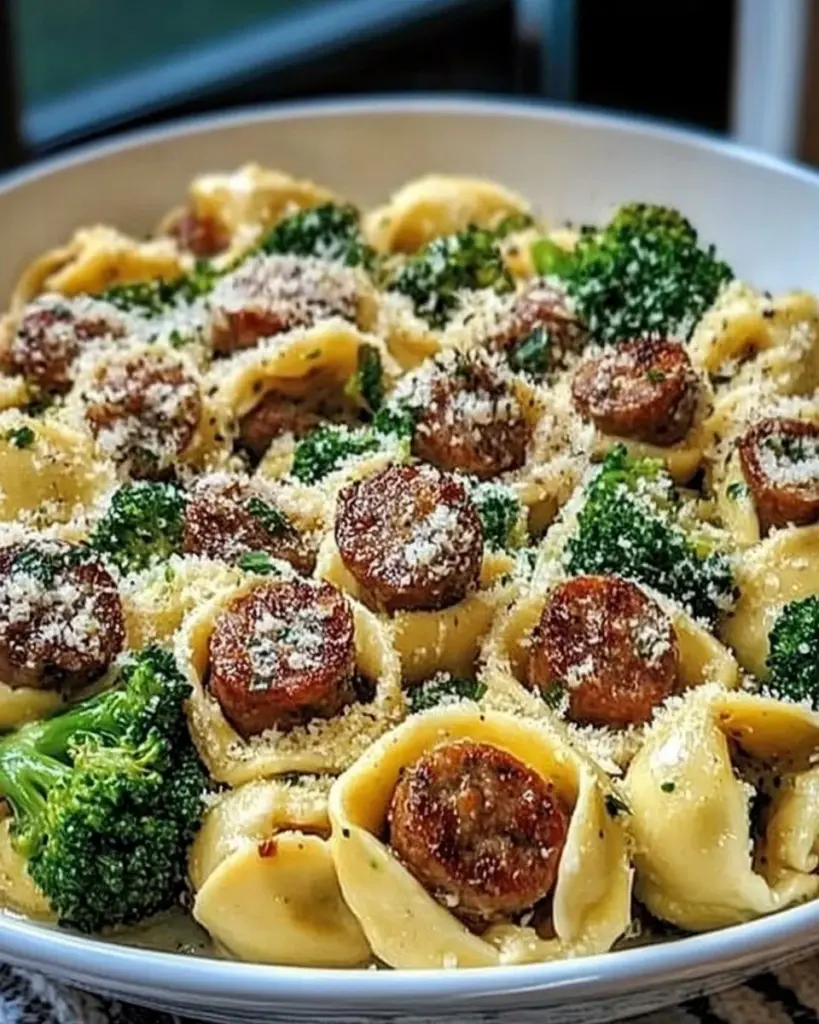 Creamy Garlic Parmesan Tortellini with sausage and broccoli on a plate